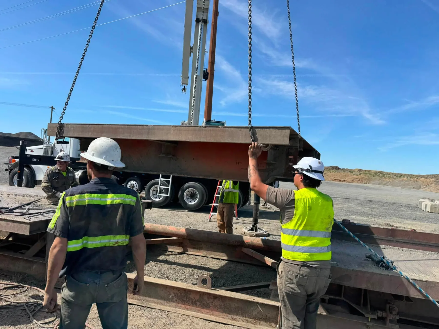 Western Scale technicians lifting a truck scale deck during service